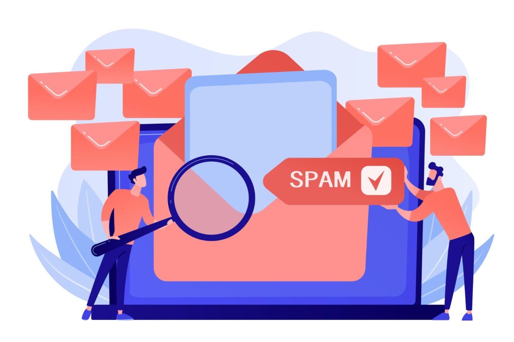 Two men next to a laptop sending too many emails, which can make spam score too high.